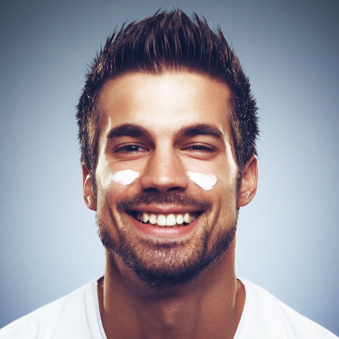 A man applying moisturizer